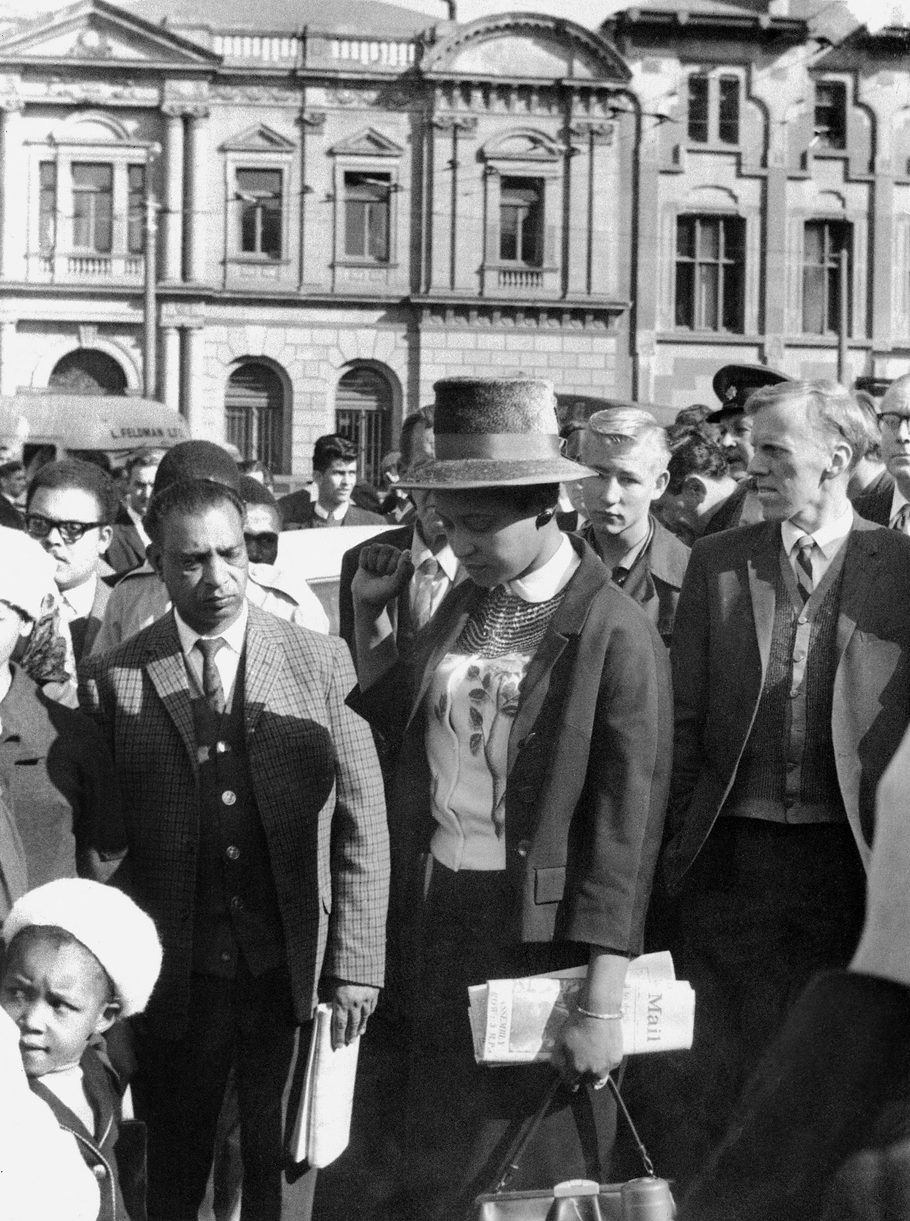 Anti-apartheid campaigner Winnie Mandela, leaves the Palace of Justice in Pretoria on June 12, 1964, with her fist clenched, after the verdict of the Rivonia Trial was given.