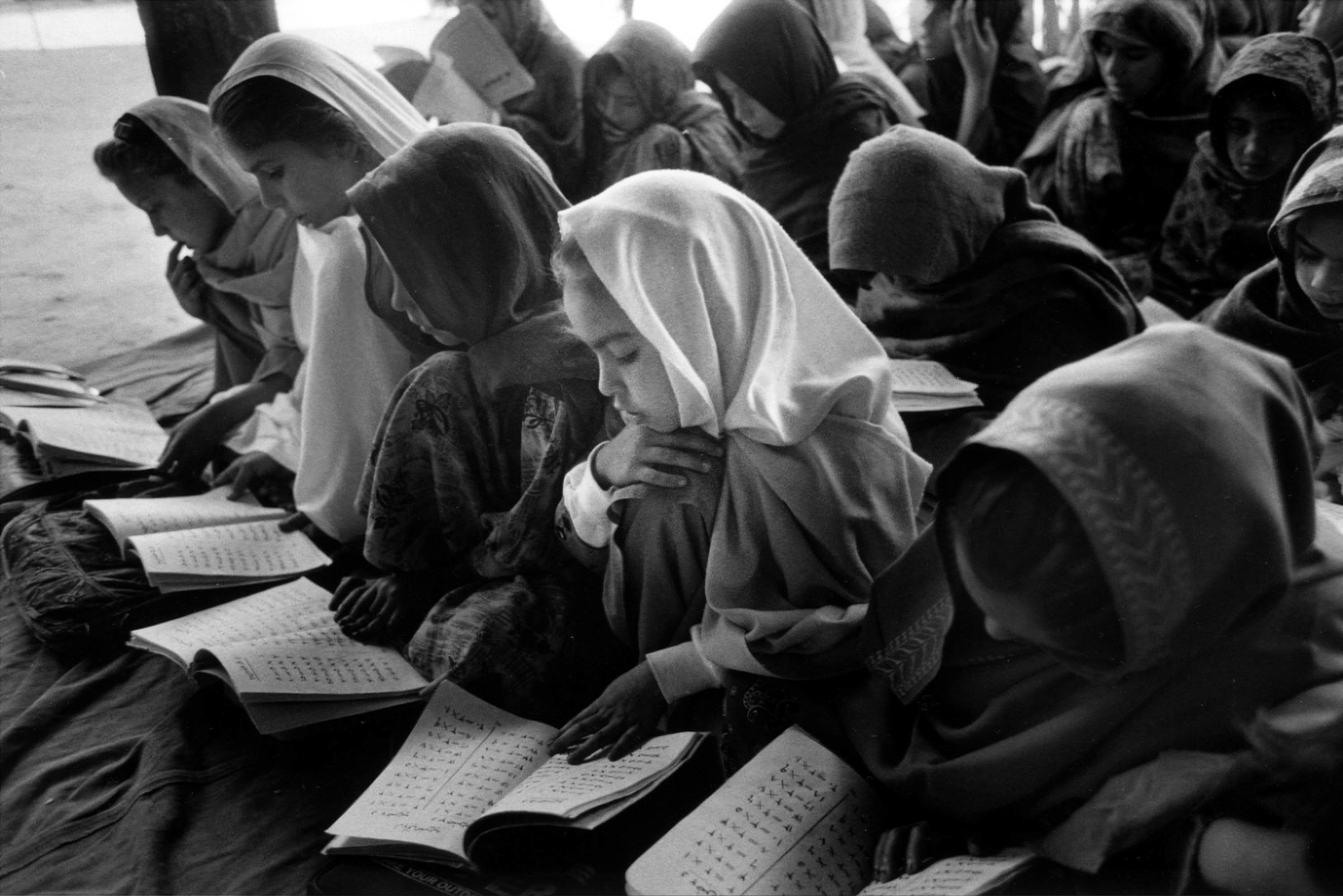 Young girls study in a secret school on the outskirts of Jalalabad, Afghanistan, November 2000