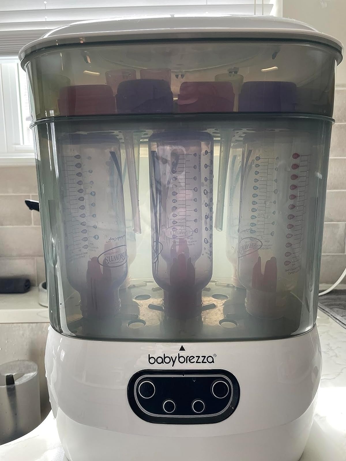 Baby Brezza appliance holds six babe  bottles wrong  its wide   chamber, positioned connected  a room  counter