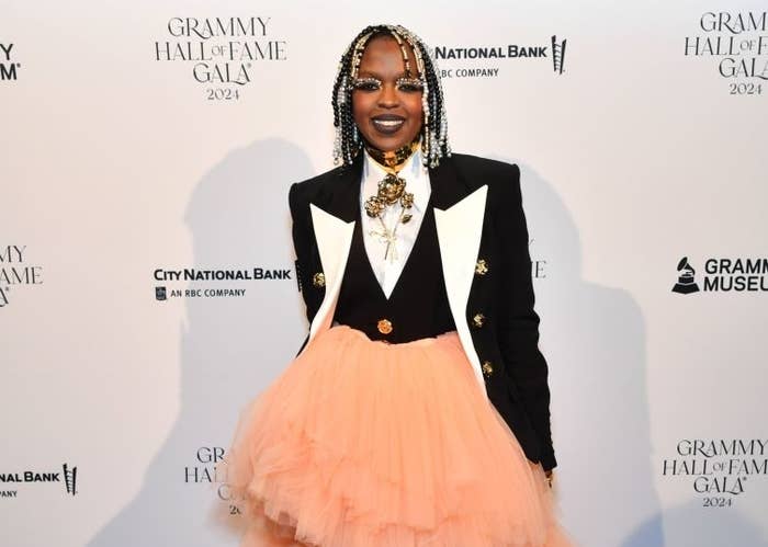 Lauryn Hill at Grammy Hall of Fame Gala 2024, wearing a blazer with gold buttons over a layered, voluminous pink tulle skirt
