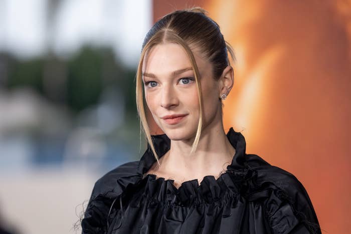 Hunter Schafer in a dark, ruffled dress at a celebrity event