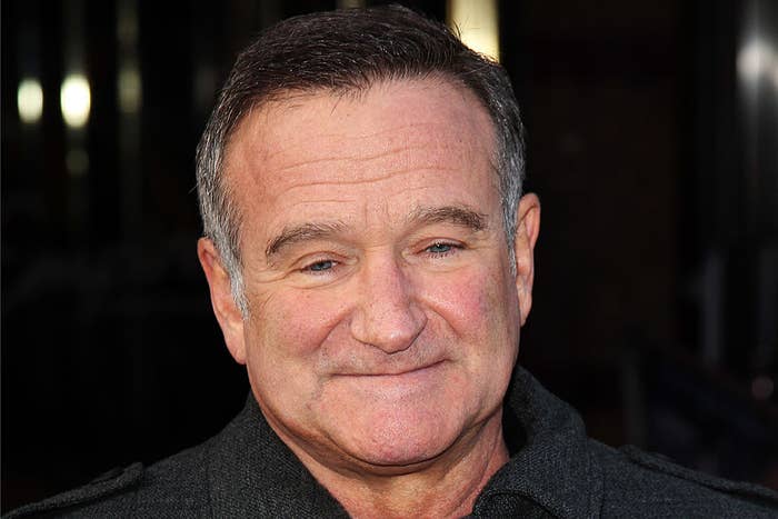 Robin Williams smiling at an event, wearing a dark jacket
