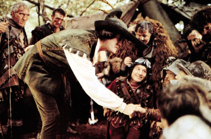 John Cleese shaking someone's hand in a scene from "Time Bandits"
