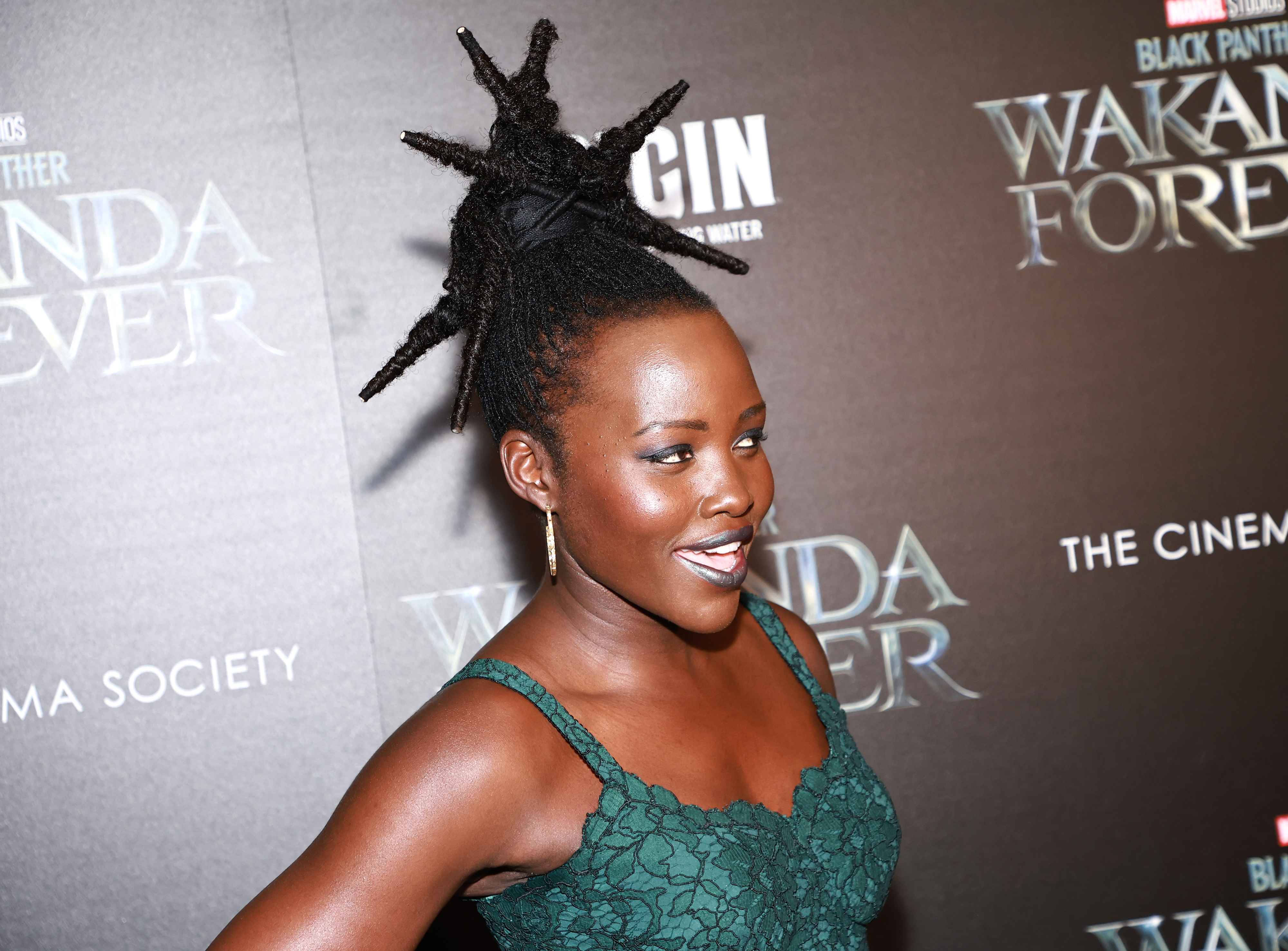 Lupita Nyong'o at the "Black Panther: Wakanda Forever" premiere, wearing a stylish sleeveless dress with intricate detailing