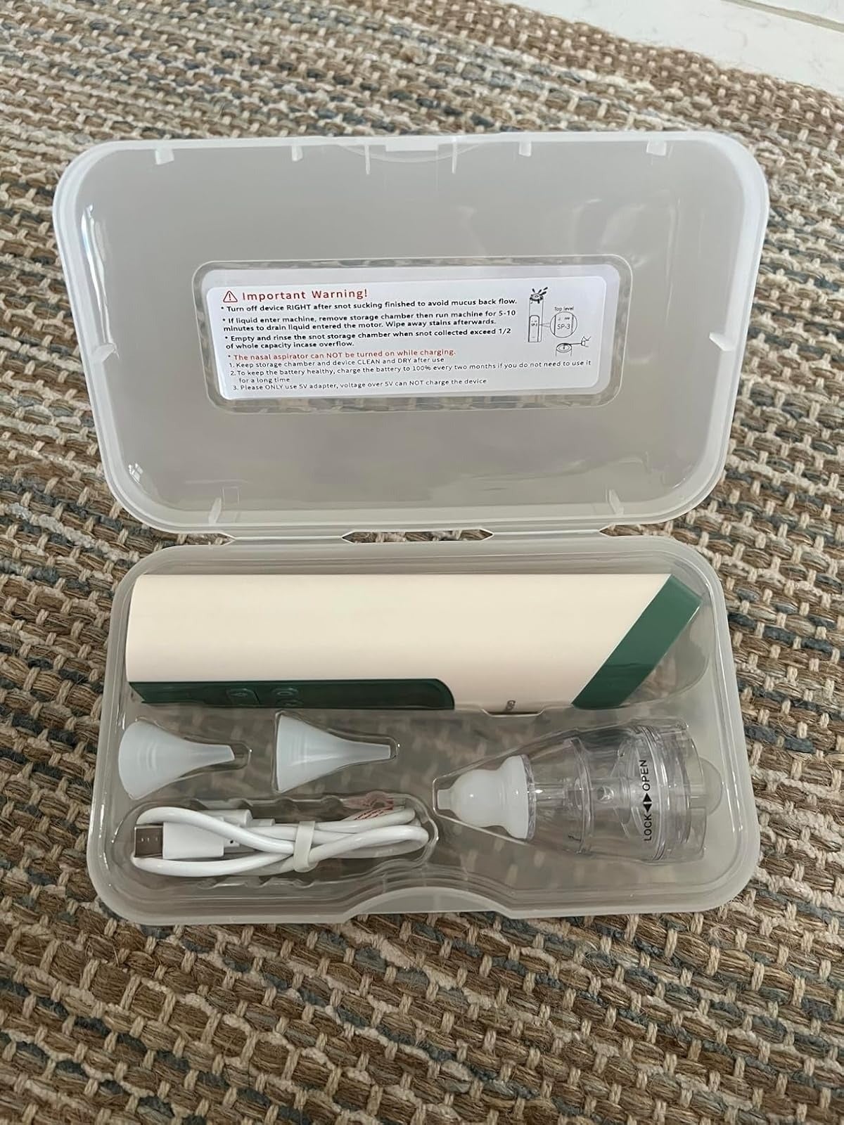 Ear cleaning kit with an receptor  vacuum cleaner, respective  nozzles, and a USB charging cablegram  successful  a integrative  lawsuit  connected  a woven surface