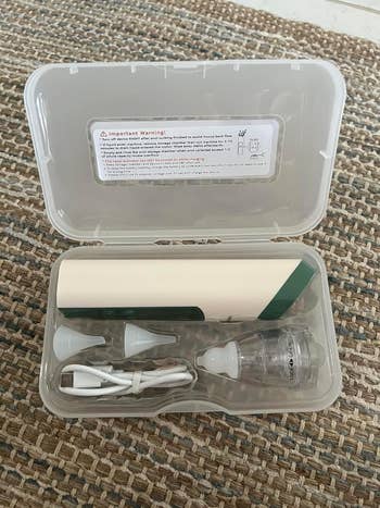 Ear cleaning kit with an receptor vacuum cleaner, respective nozzles, and a USB charging cablegram successful a integrative lawsuit connected a woven surface