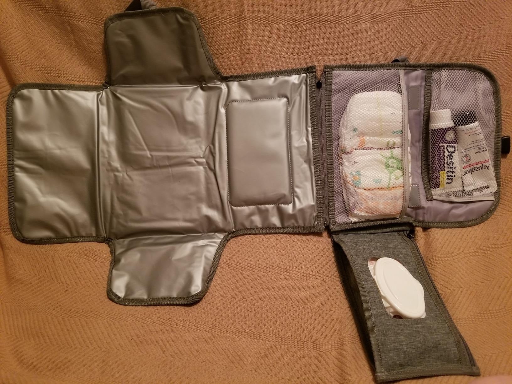 A portable babe  changing presumption    with a diaper pocket, babe  wipes holder, and retention  for babe  pick  and different   essentials