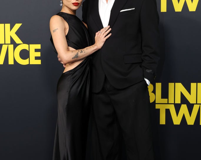 Zoe Kravitz in an elegant black gown and Channing Tatum in a black suit pose together at a red carpet event