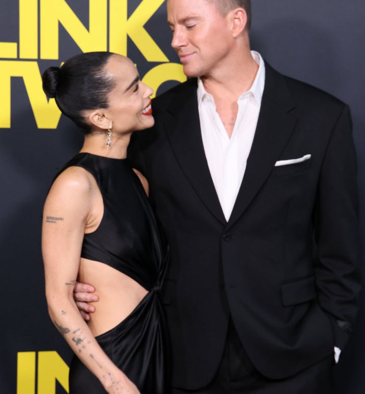 Zoë Kravitz in a chic cut-out black gown and Channing Tatum in a classic black suit smile at each other at a &quot;Link Two&quot; premiere event