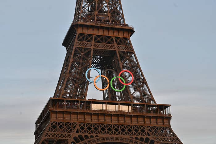 The Eiffel Tower adorned with Olympic rings, signifying its role in the upcoming sports events
