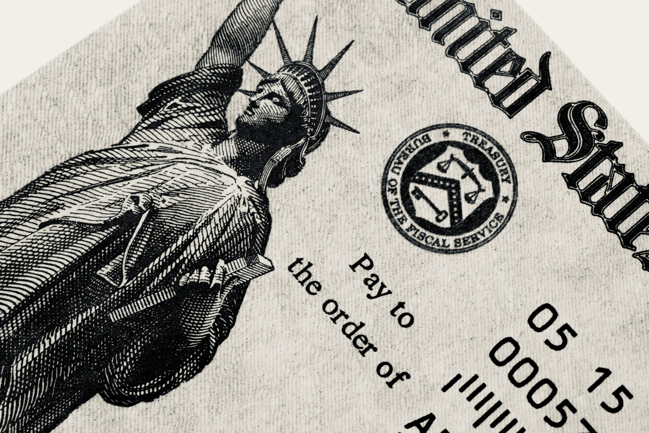 Close-up view of a U.S. Treasury check featuring a detailed image of the Statue of Liberty and routing numbers on the right