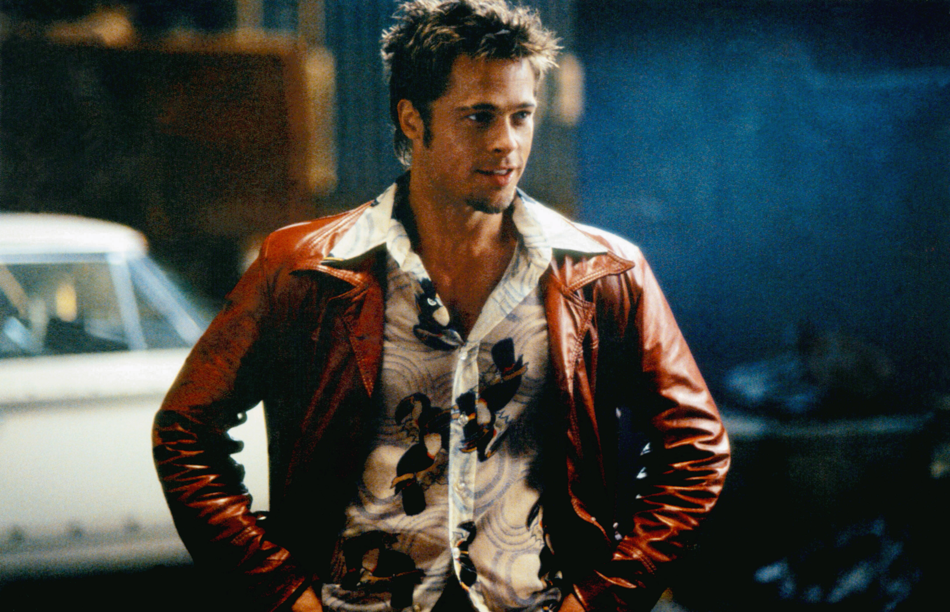 Brad Pitt in a patterned shirt and leather jacket in a scene from "Fight Club"