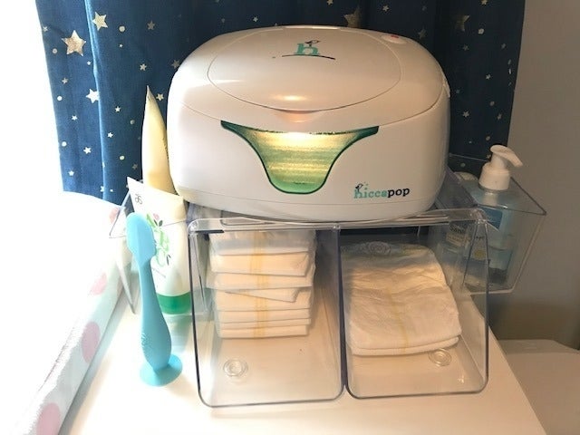 Diaper changing presumption    with a hitch   warmer, stocked with diapers and babe  tegument  attraction   products