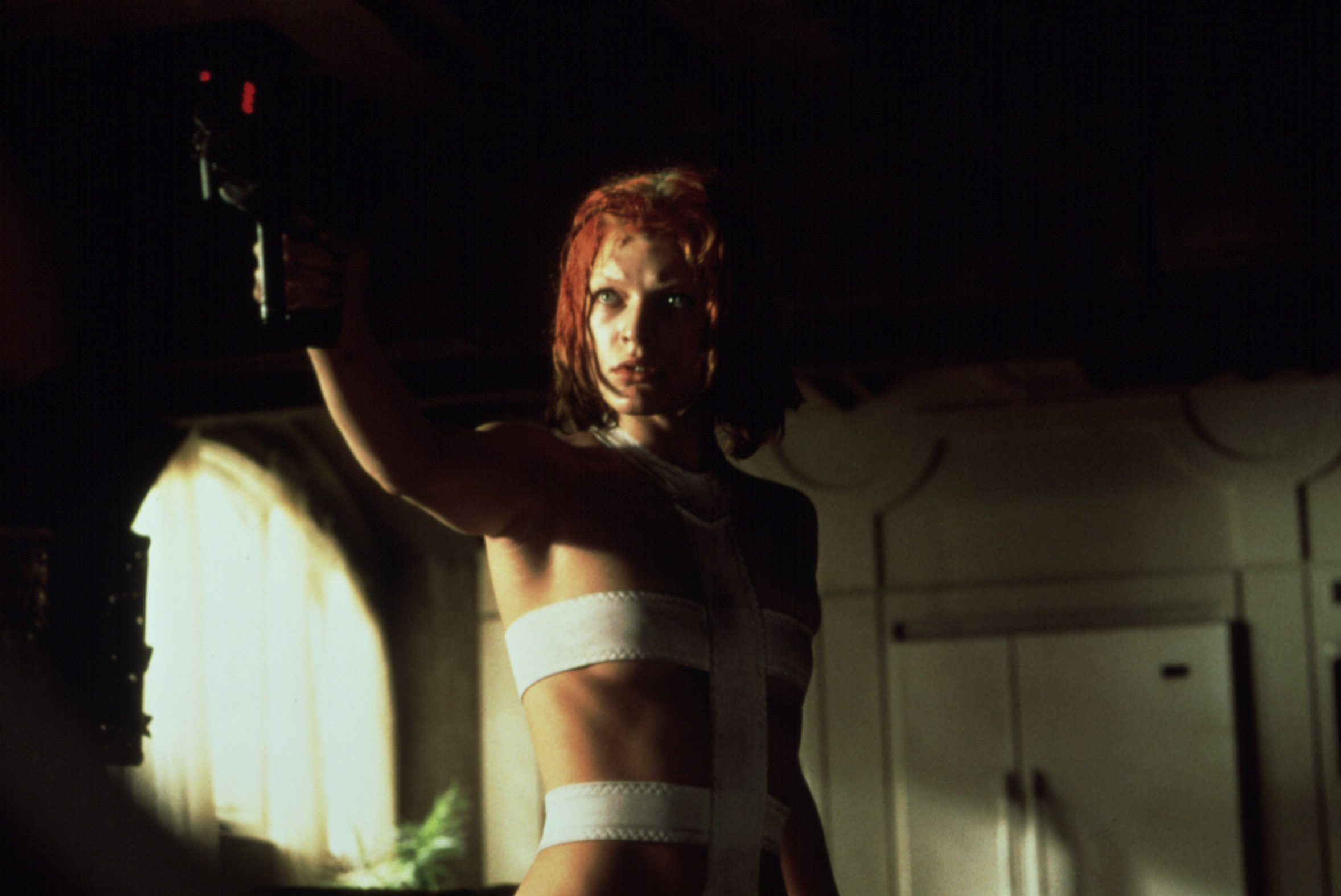 Milla Jovovich holding a gun in "The Fifth Element"