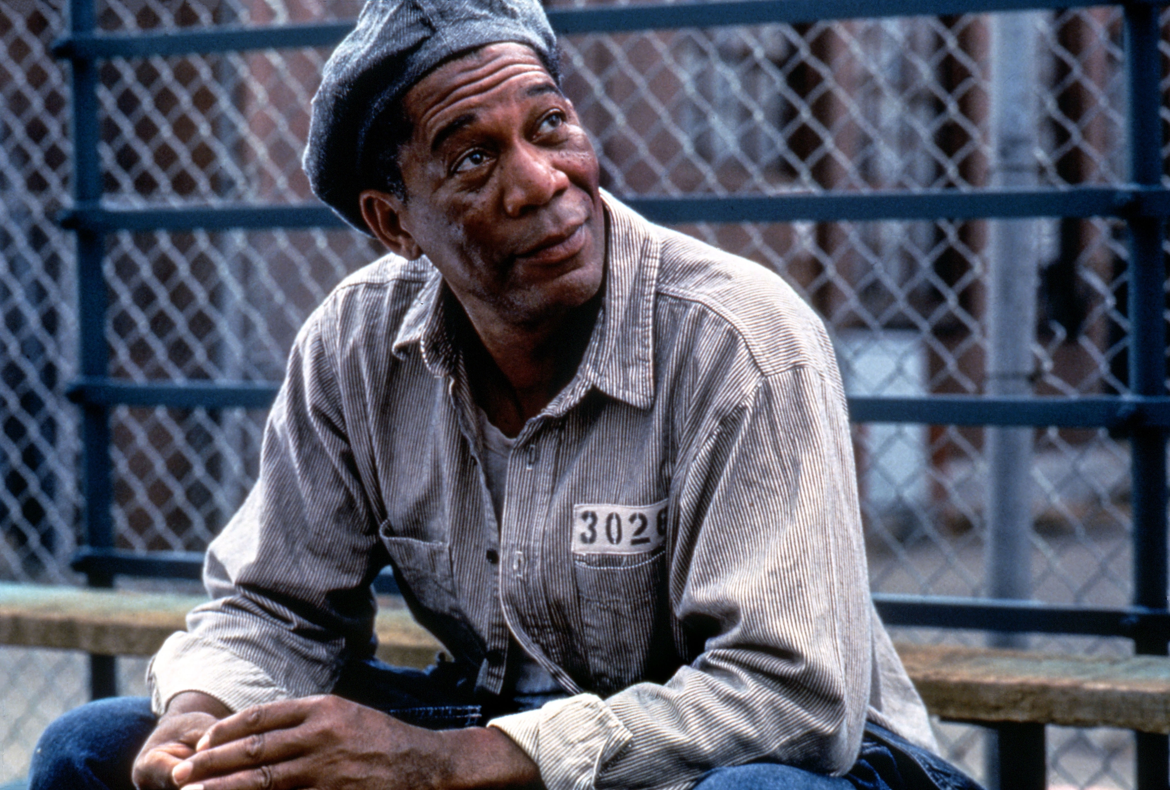 Morgan Freeman in button-up shirt and cap in a scene from "The Shawshank Redemption"