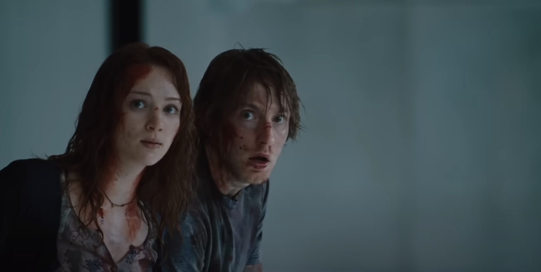 Kristen Connolly and Fran Kranz in a scene from &quot;The Cabin in the Woods,&quot; looking frightened with blood on their faces and clothing