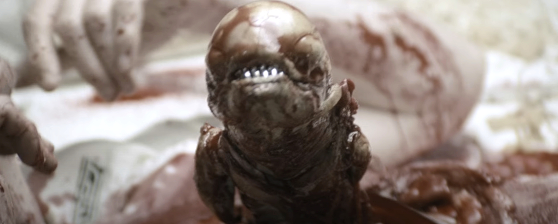 Alien character from the movie &quot;Alien&quot; appears emerging from a host, showcasing its teeth and otherworldly features