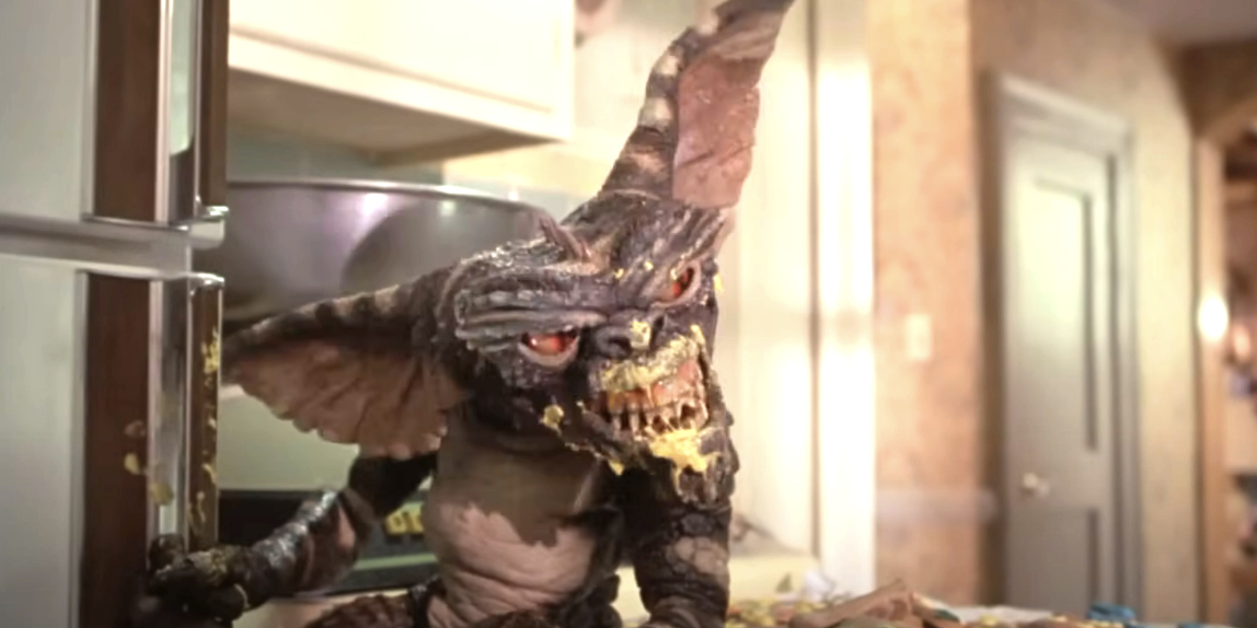 Gremlin creature from the movie &quot;Gremlins&quot; causing mischief in a kitchen