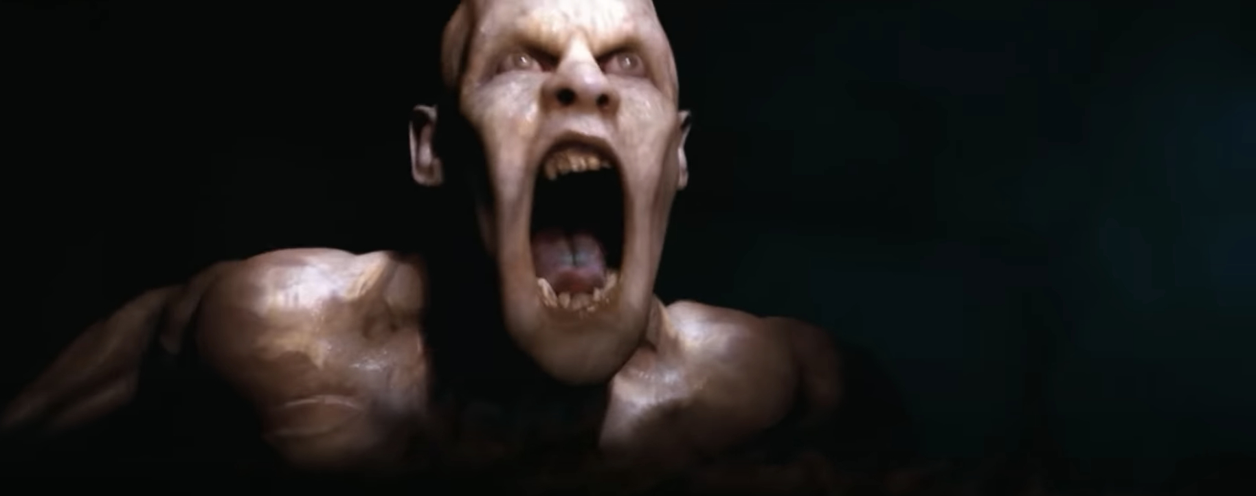 Gorr the God Butcher screams, shirtless, showing muscular frame and menacing expression in a dark setting, from the movie &quot;Thor: Love and Thunder.&quot;