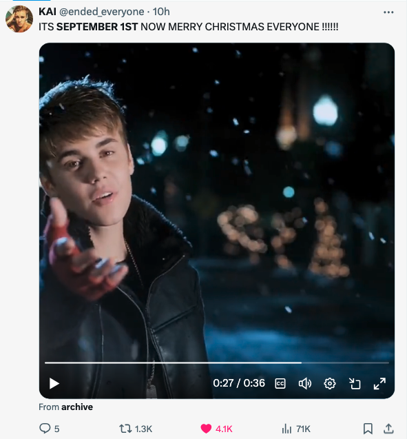 Justin Bieber singing in a festive outdoors scene as snow falls, with tweet text "ITS SEPTEMBER 1ST NOW MERRY CHRISTMAS EVERYONE!!!!!!"