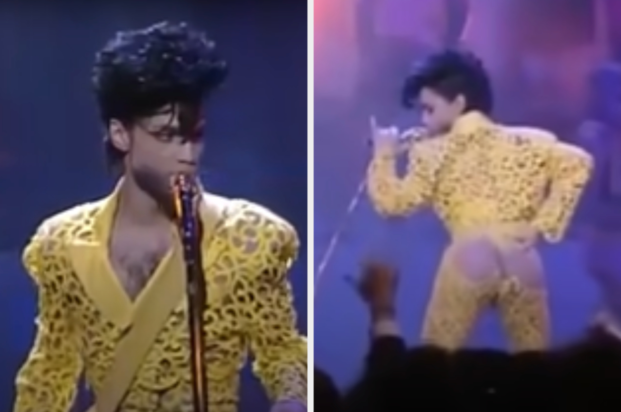 Prince performing on stage, wearing a lacy yellow outfit with cut-out details and an exposed back