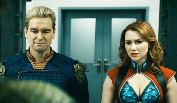 The image shows two characters from The Boys: Homelander and Firecracker. Homelander is in his superhero costume, and Starlight is in a revealing blue and red ensemble