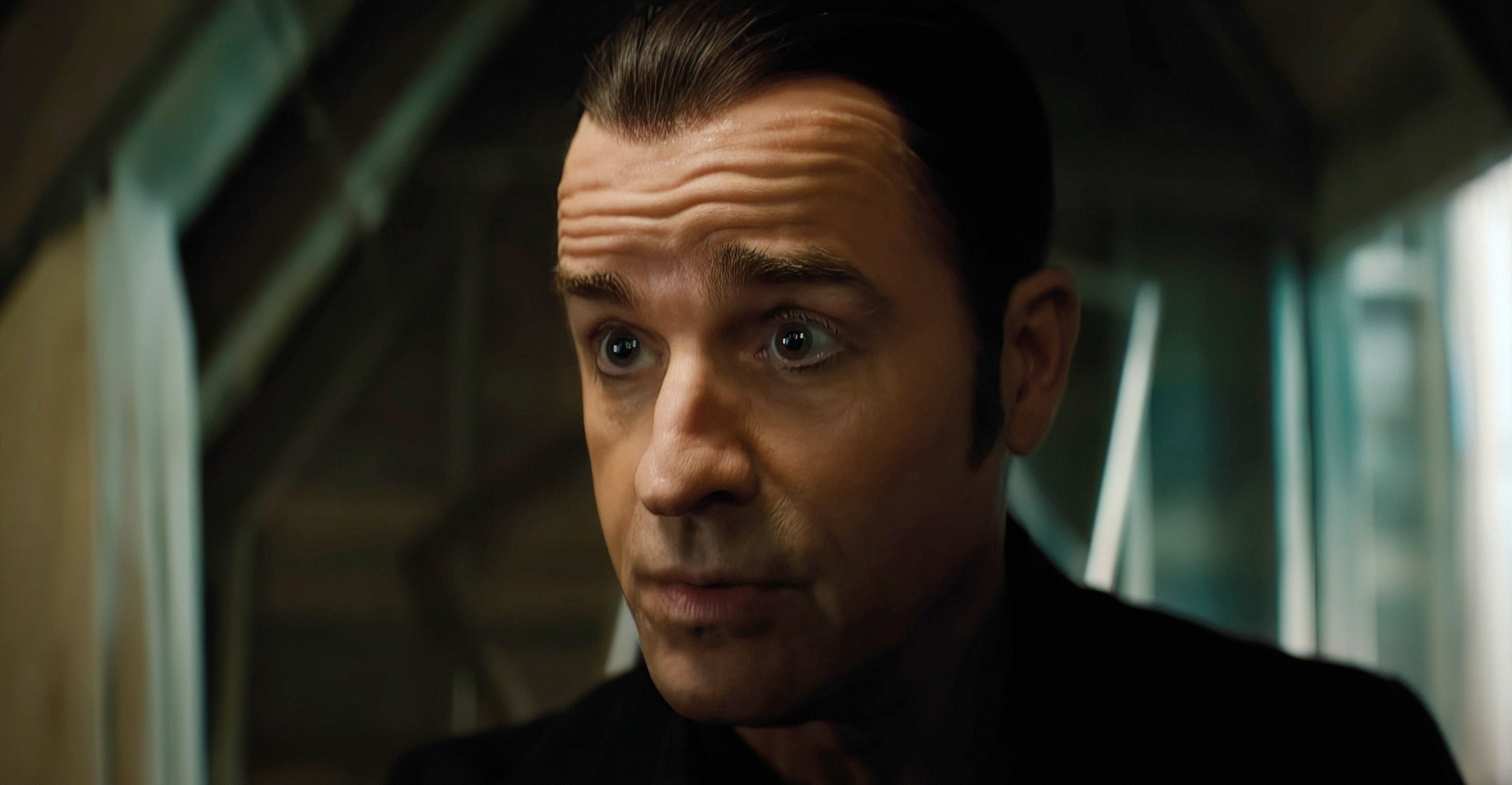 Justin Theroux portraying a character in a dramatic scene with a serious expression