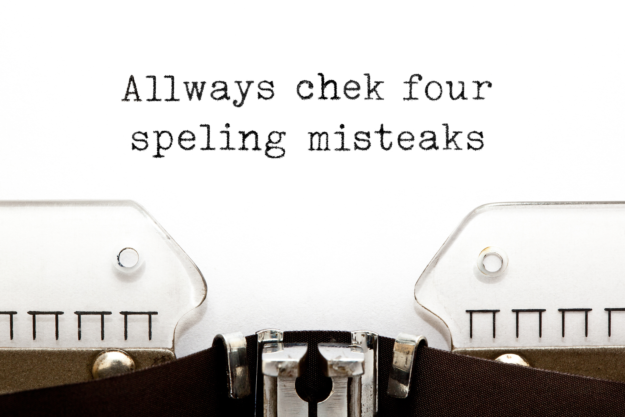 A typewriter page with the humorous message: "Allways chek four speling misteaks"