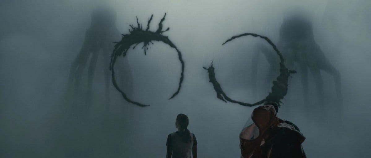People observing two large alien symbols on a foggy glass wall in a sci-fi scene from the film &quot;Arrival.&quot;
