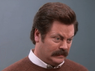 Nick Offerman making an exaggerated comical facial expression while raising his eyebrows