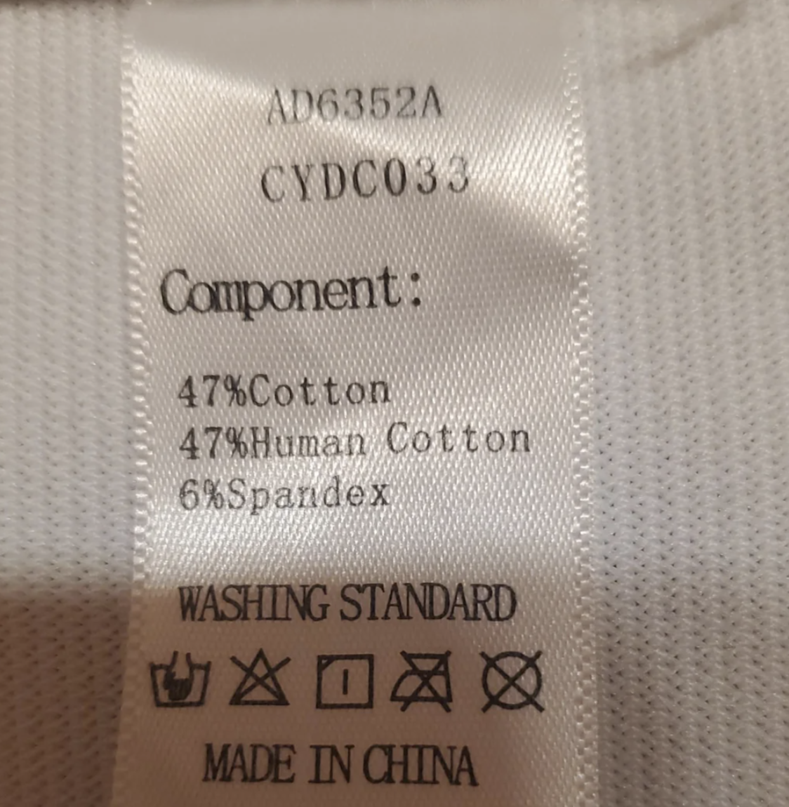 Clothing label with components listed as 47% Cotton, 47% Human Cotton, 6% Spandex, along with washing instructions and "Made in China."