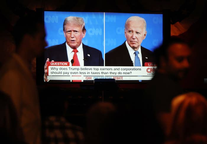 Donald Trump and Joe Biden are shown on CNN during a presidential debate. Text on screen asks, &quot;Why does Trump believe top earners and corporations should pay even less in taxes than they do now?&quot;