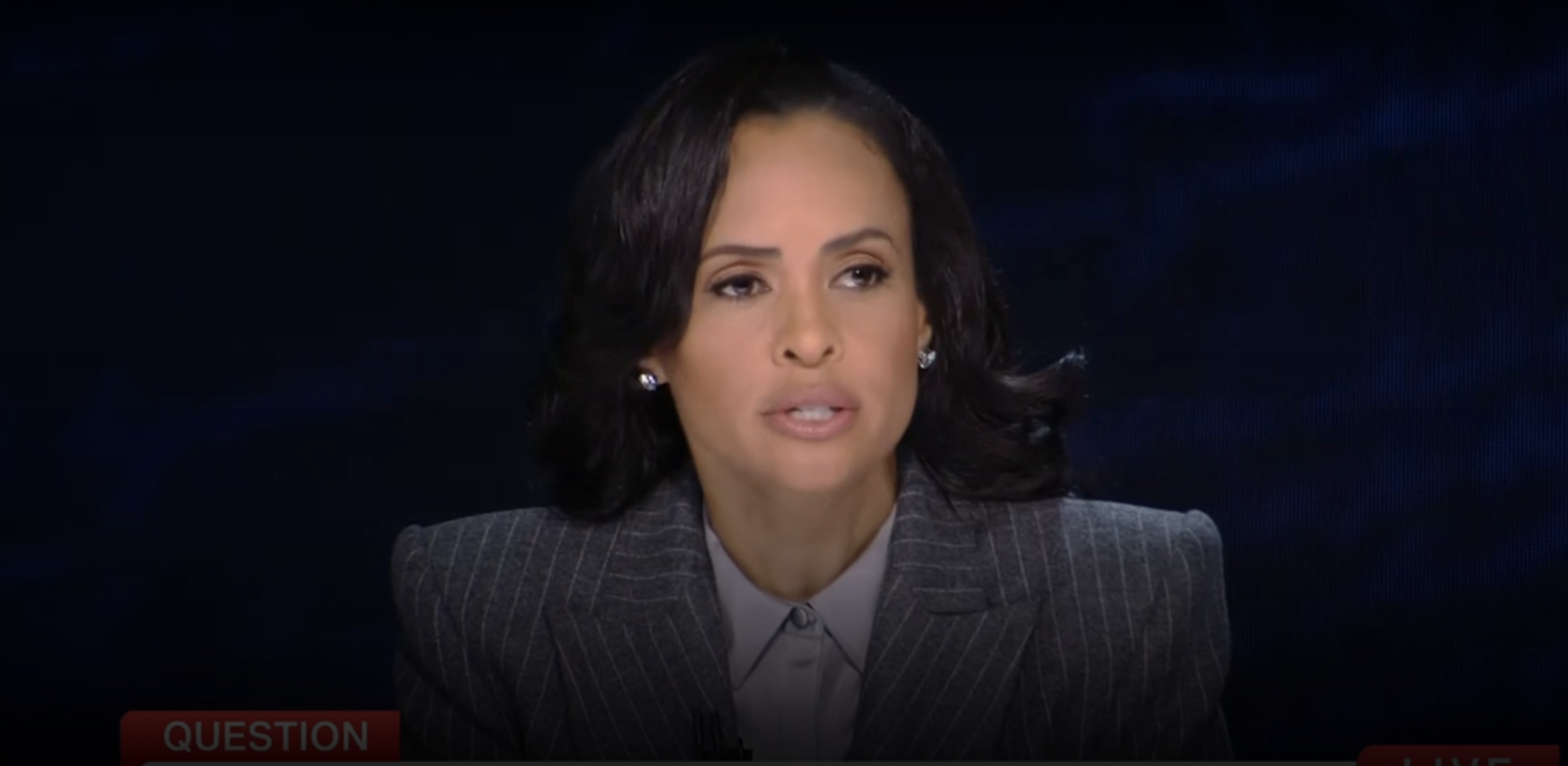 Linsey Davis is speaking on a news broadcast, wearing a suit jacket and earrings. The word "QUESTION" is partly visible at the bottom