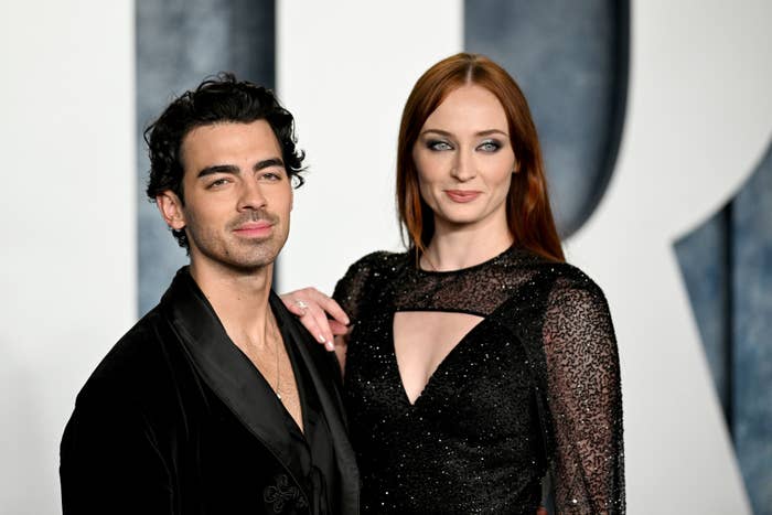 Joe Jonas in a dark suit and Sophie Turner in a sparkling dark dress, posing together at a formal event