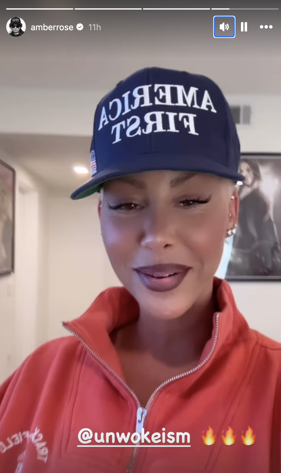 Amber Rose is wearing a cap that says &quot;America First&quot; and a red zip-up jacket. The text &quot;unwokeism&quot; with fire emojis is at the bottom of the image