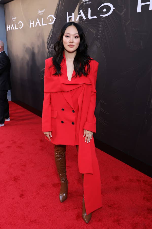 Yerin Ha poses in a stylish asymmetrical blazer and brown thigh-high boots on the red carpet at a &quot;Halo&quot; event