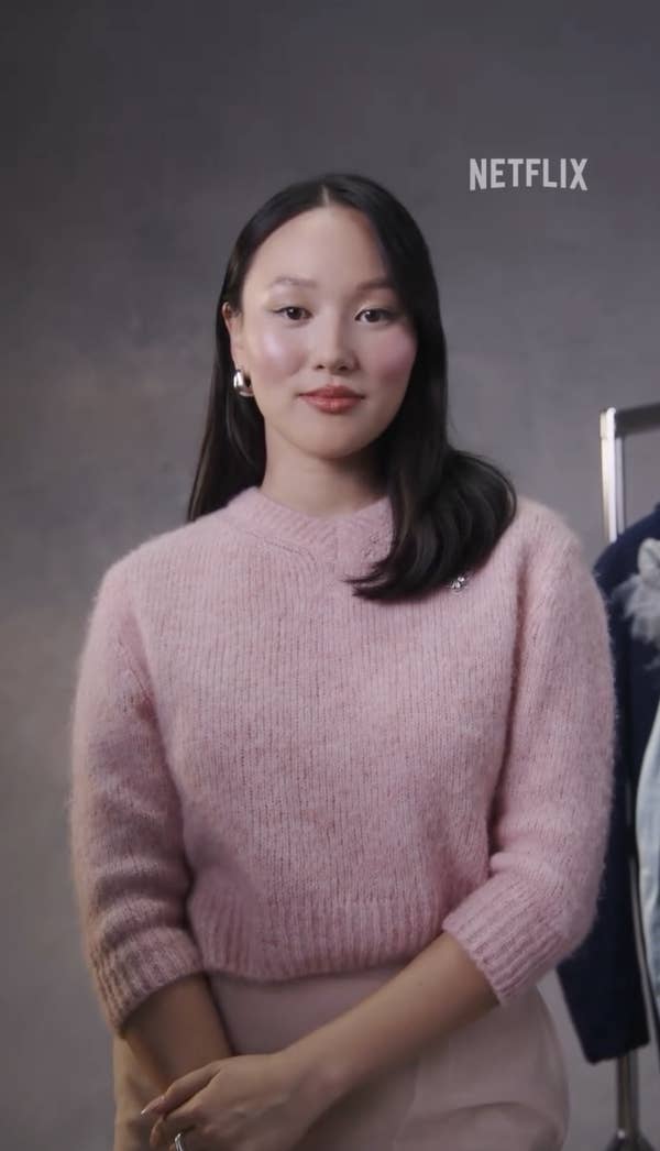 Yerin Ha stands in front of a plain backdrop, wearing a textured sweater. The Netflix logo is visible in the upper right corner