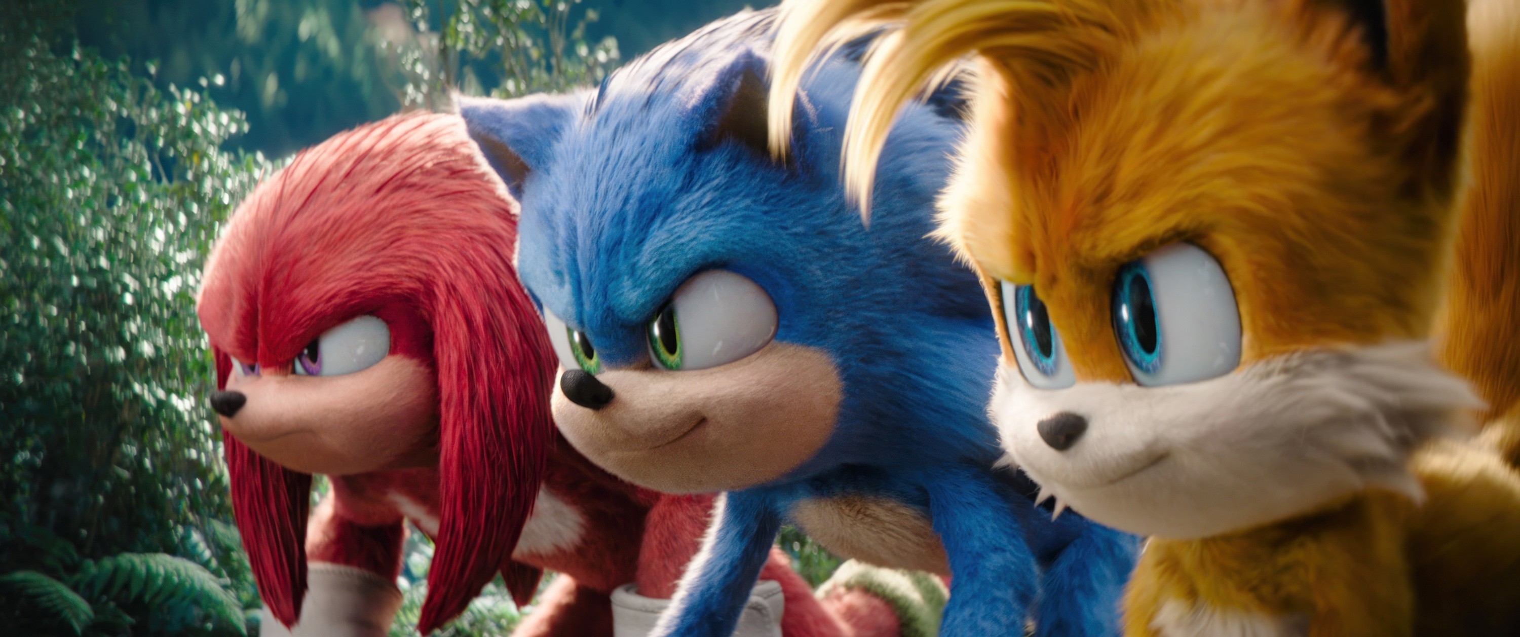 Knuckles, Sonic, and Tails are in an action-ready stance in a forest, from the Sonic the Hedgehog movie series