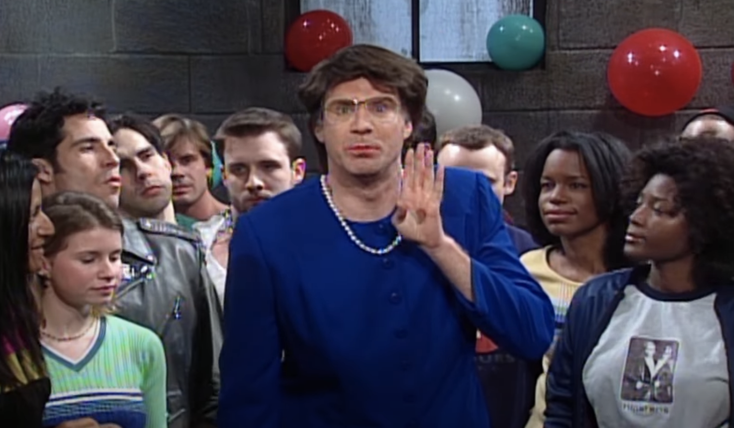 Will, in a blue dress and pearls, humorously gestures amid a crowd in a sketch setting with balloons on the wall
