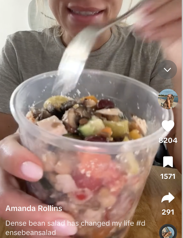 Amanda Rollins holds a fork over a container of dense bean salad, captioned, "Dense bean salad has changed my life #densebeansalad."