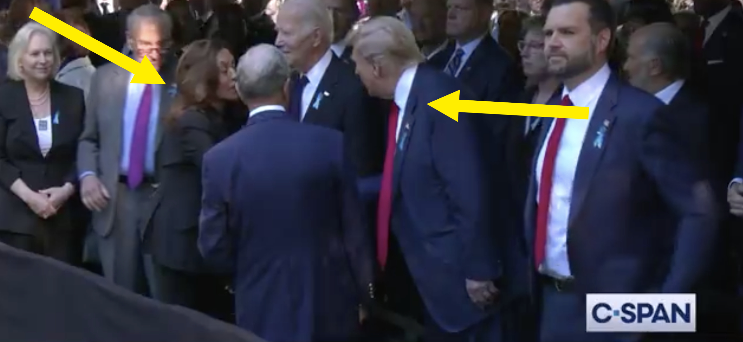 Public figures, including Joe Biden and Donald Trump, are seen conversing and shaking hands at an event with other attendees present, captured on C-SPAN
