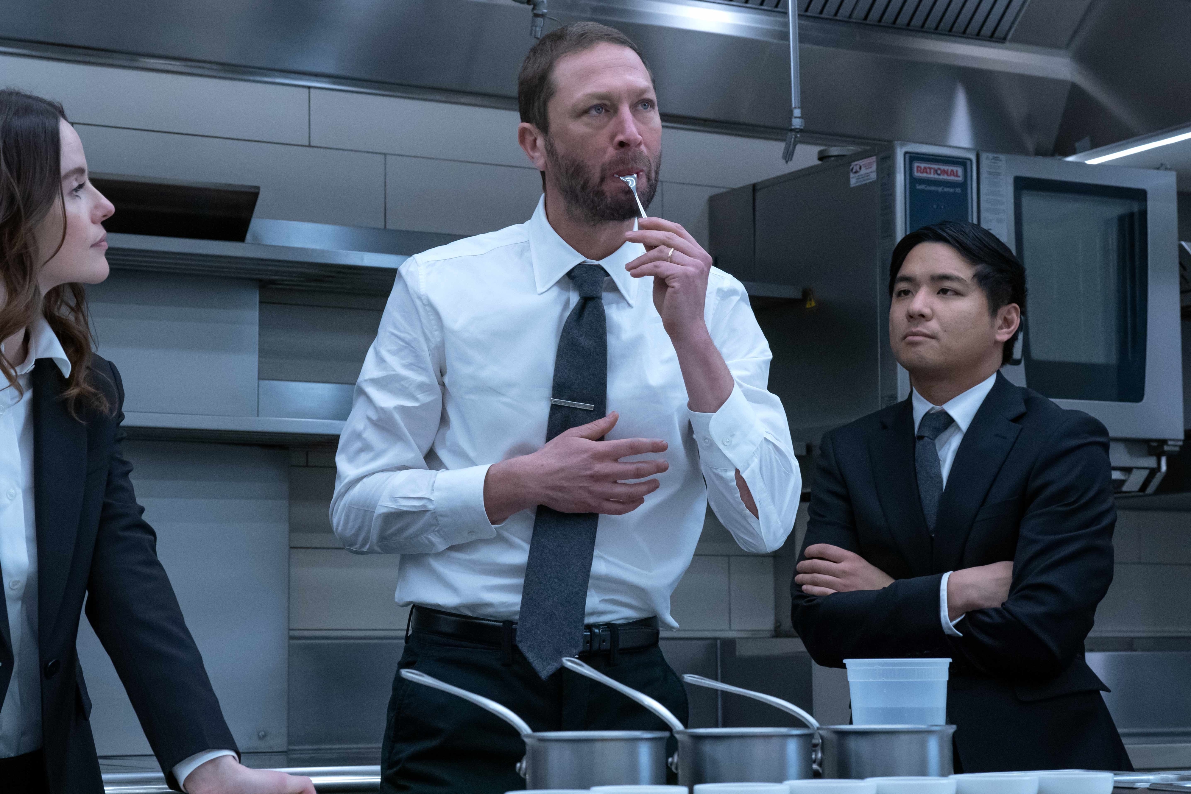 Ebon Moss-Bachrach tasting food in a restaurant kitchen in a scene from &quot;The Bear&quot;