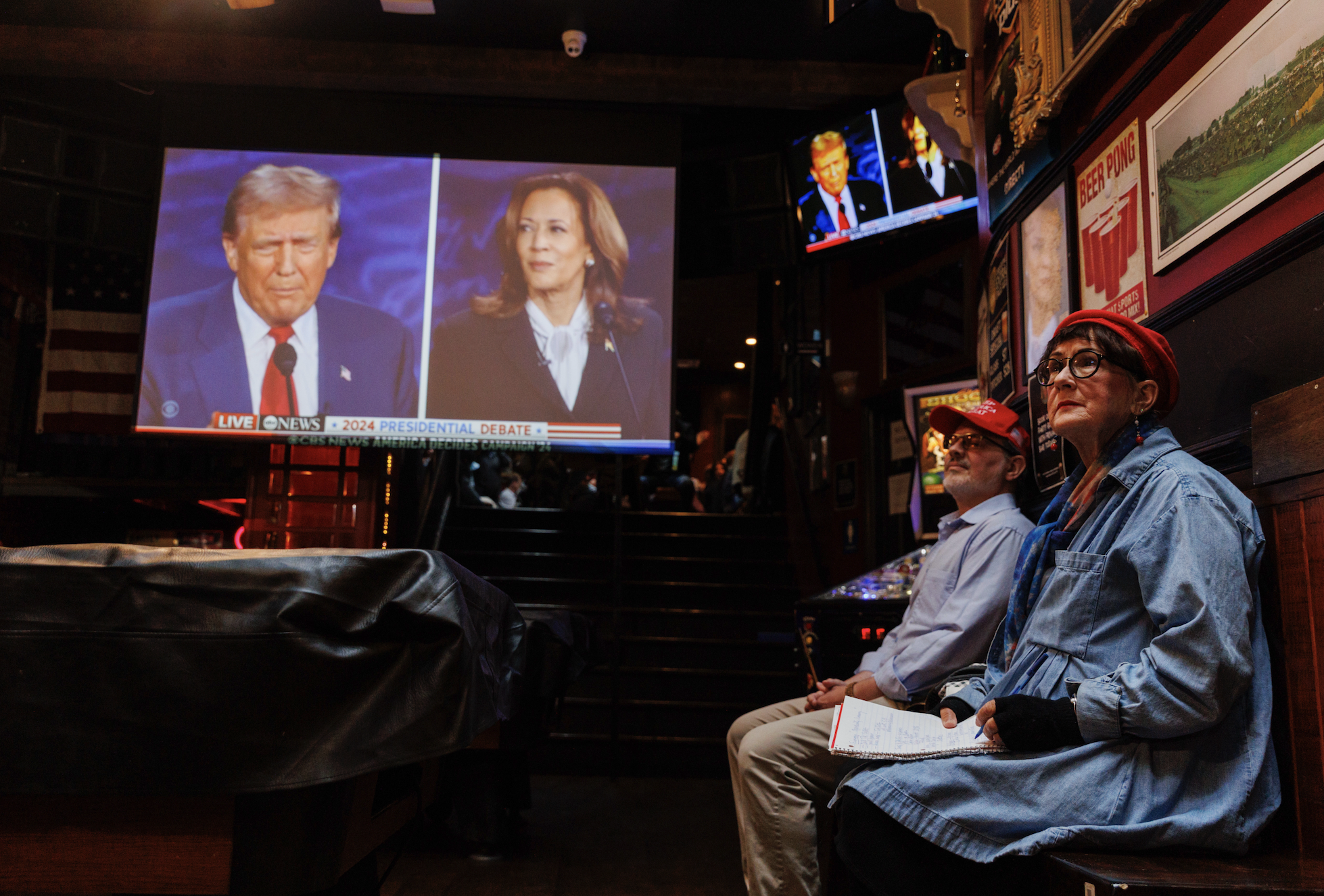 People watching live broadcast of the 2024 presidential debate between Donald Trump and Kamala Harris at a public venue