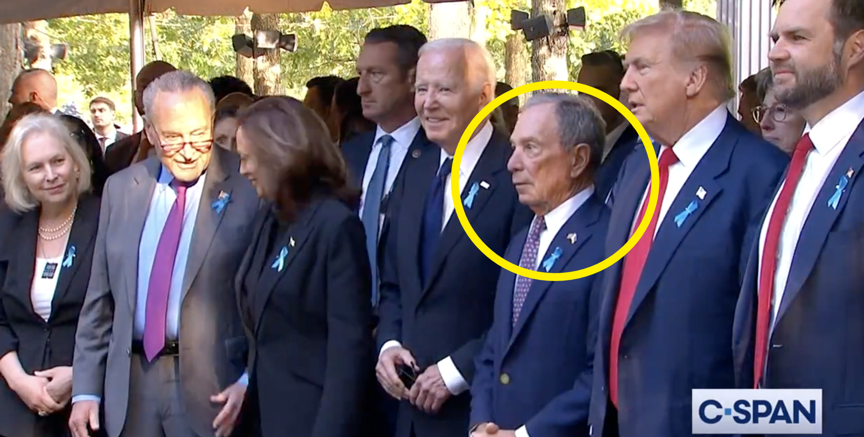 Kirsten Gillibrand, Chuck Schumer, Kamala Harris, Joe Biden, Michael Bloomberg, and Donald Trump stand together at a public event wearing suits