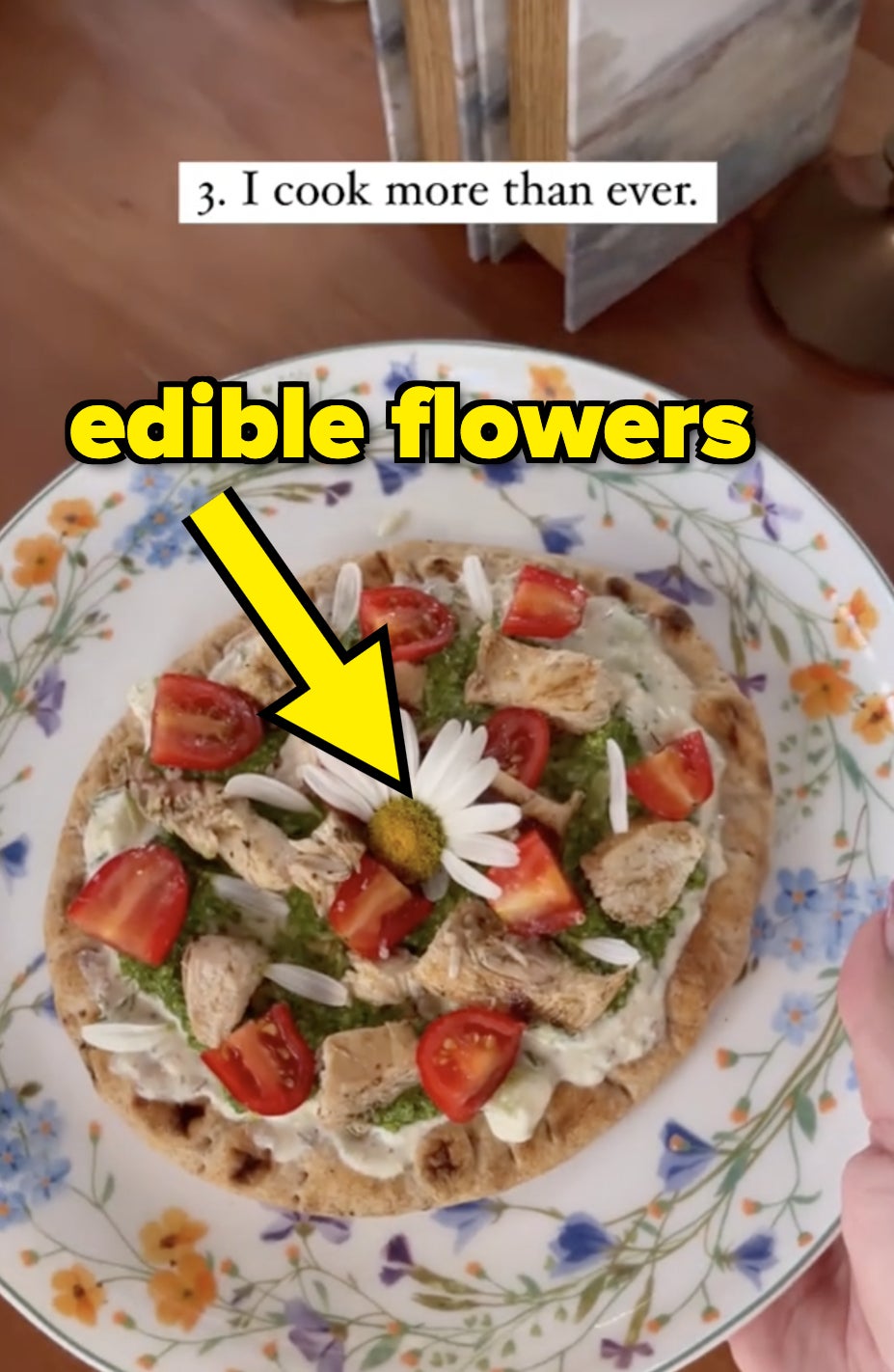 A plate of food with a flower garnish. Text on the image reads: "I cook more than ever"