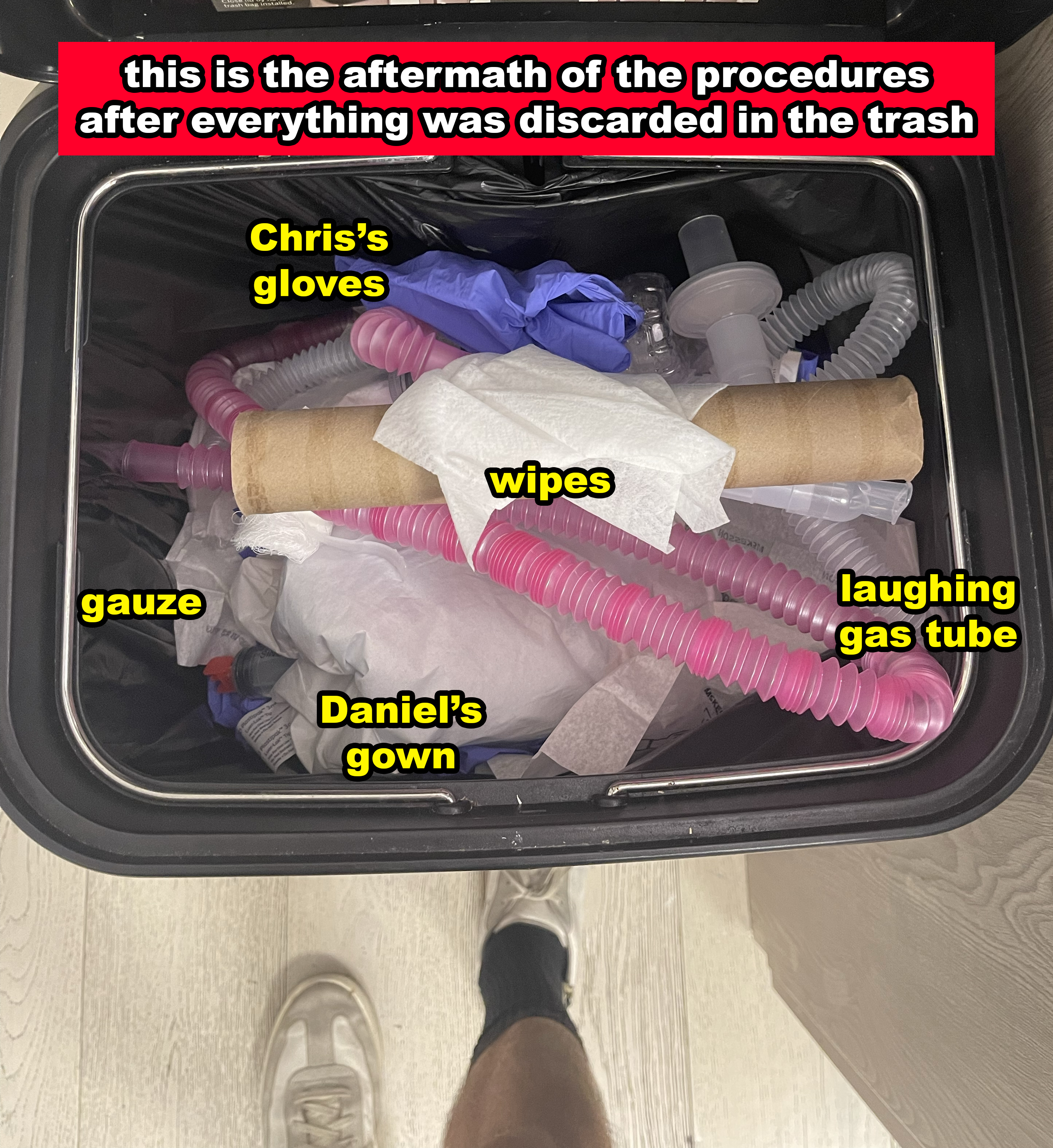 Trash can filled with medical waste labeled as Chris's gloves, wipes, gauze, Daniel's gown, and a laughing gas tube