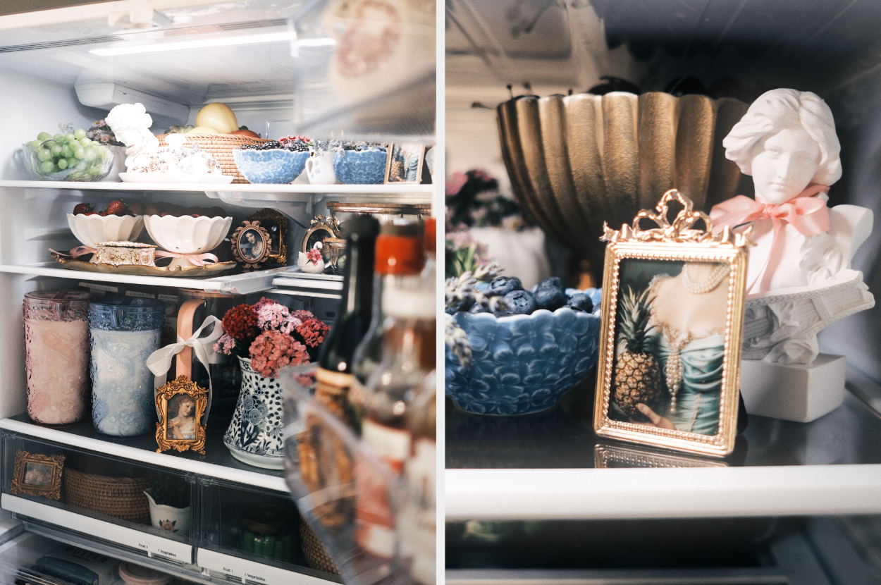 A stylishly arranged refrigerator with neatly placed decorative items including framed artwork, cups, vases, and baskets