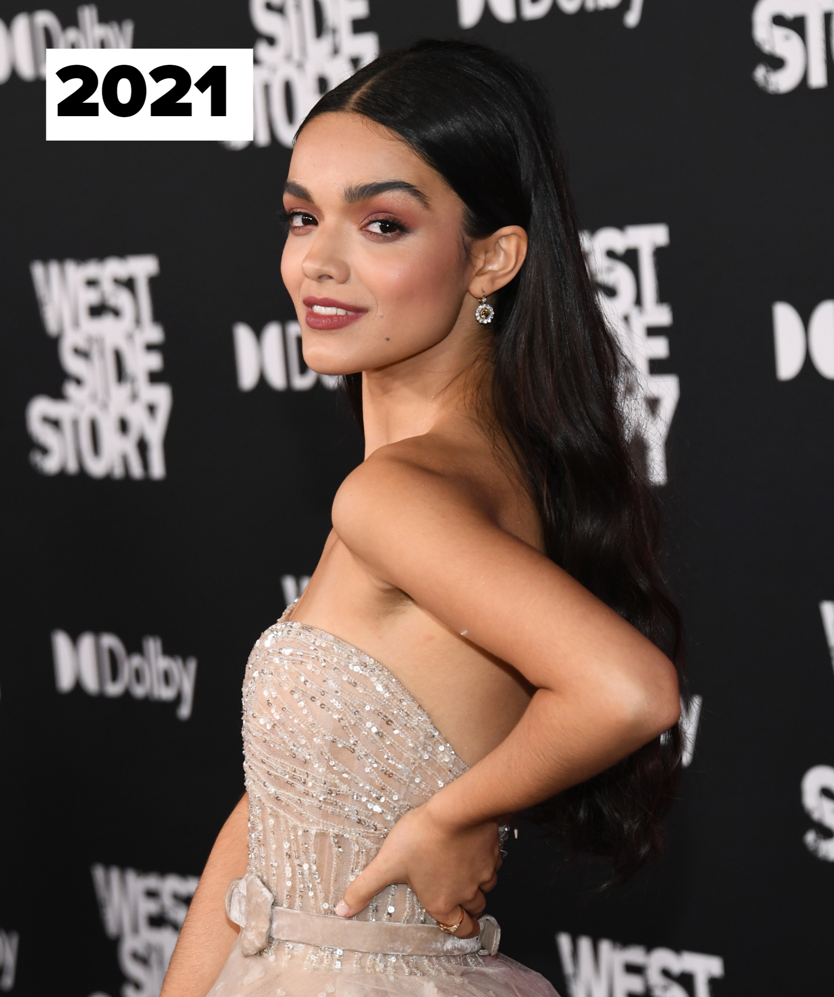 Rachel Zegler on the red carpet at the "West Side Story" premiere, wearing a strapless, embellished gown with a fitted bodice and flowing skirt