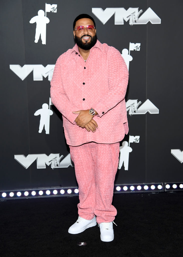 DJ Khaled on the MTV VMA red carpet, wearing a stylish matching textured suit and sneakers