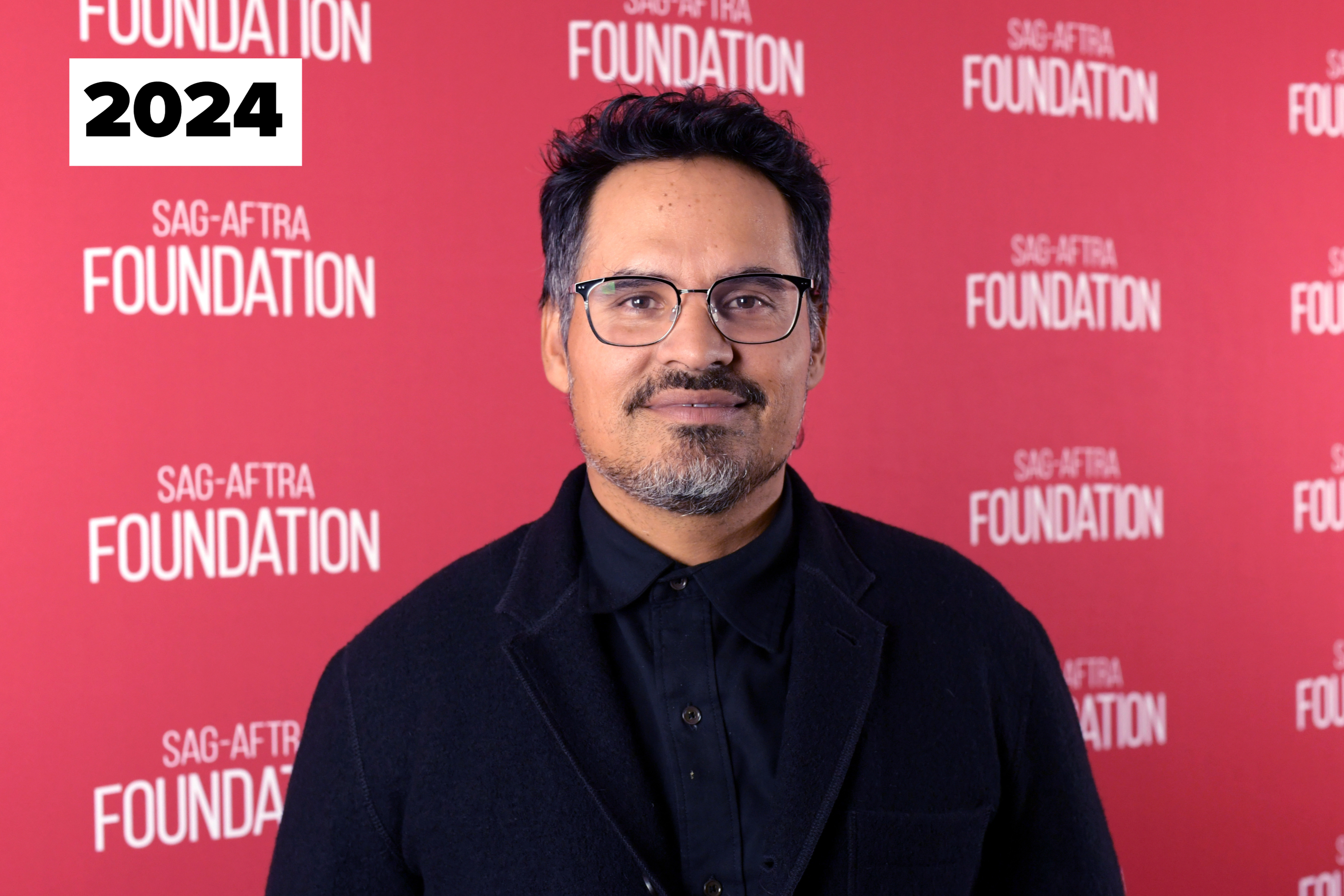 Michael Peña at a SAG-AFTRA Foundation event, wearing glasses and a black jacket over a buttoned shirt